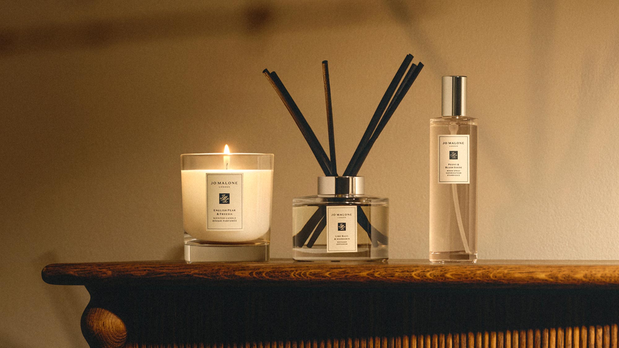 Jo Malone London home fragrance collection including lit candle, room diffuser and cologne spray