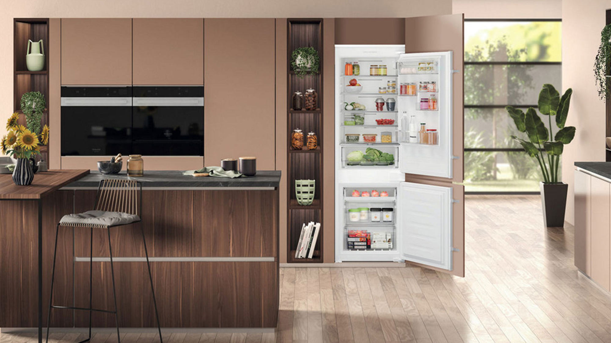 Modern kitchen with white integrated fridge-freezer, dark wood cabinetry, black built-in oven, and pendant lighting