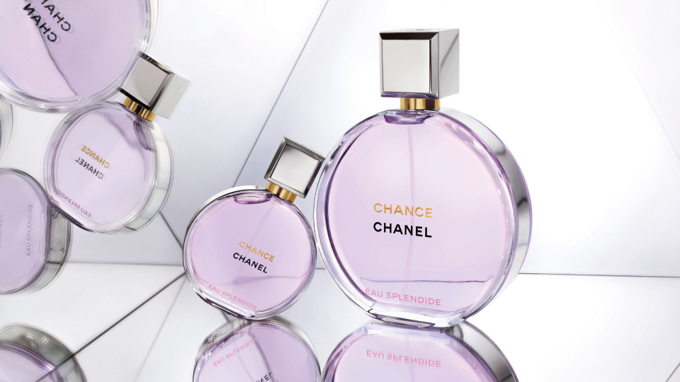 Two bottles of Chanel Chance perfume with reflections on mirrored surfaces.