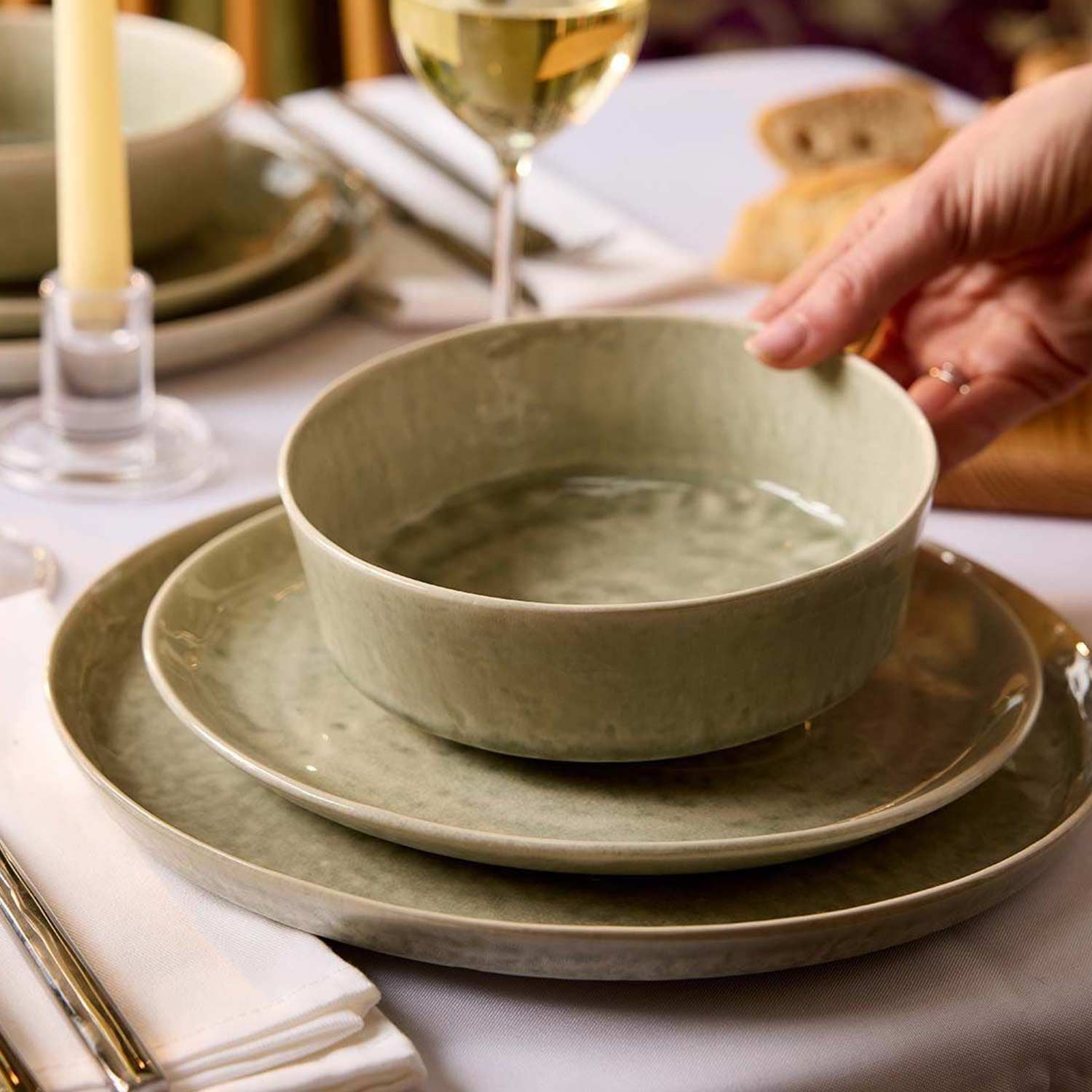 Elegantly set dining table with premium plates, glasses and cutlery for a summer dinner