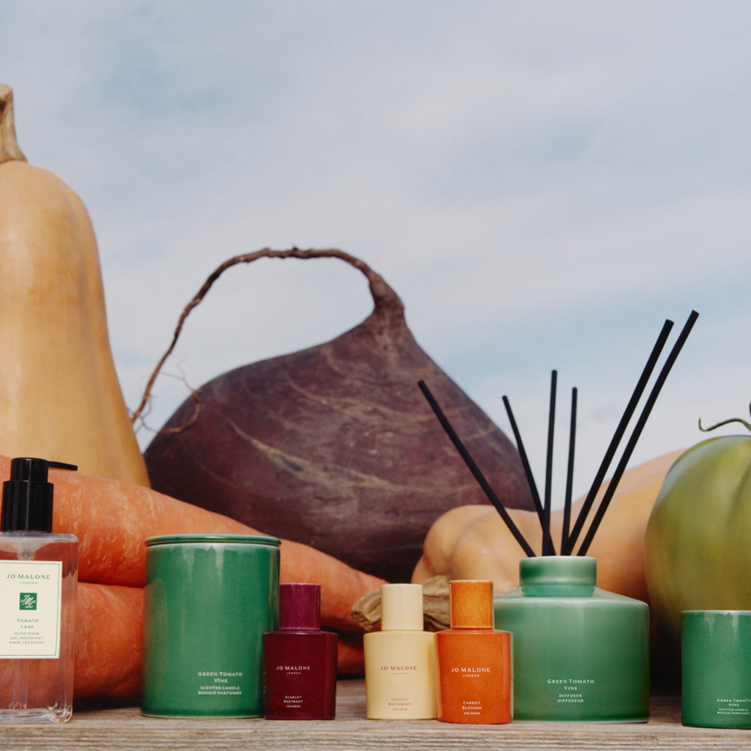 New harvest-inspired fragrances from Jo Malone London, featuring coloured glass bottles and diffuser with vegetable accents.
