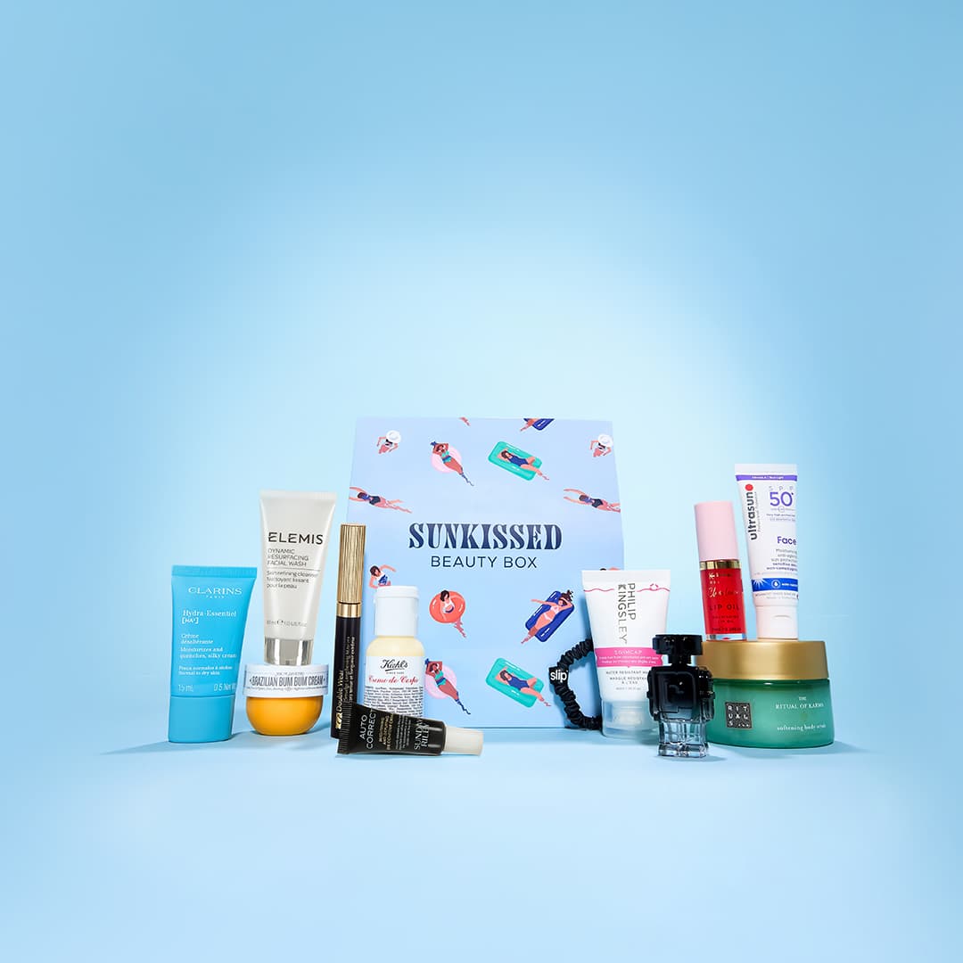 A collection of beauty products arranged around a decorative box labelled 'Sunkissed Beauty Box.' The items include creams, lotions, and tubes from various brands, set against a light blue background.