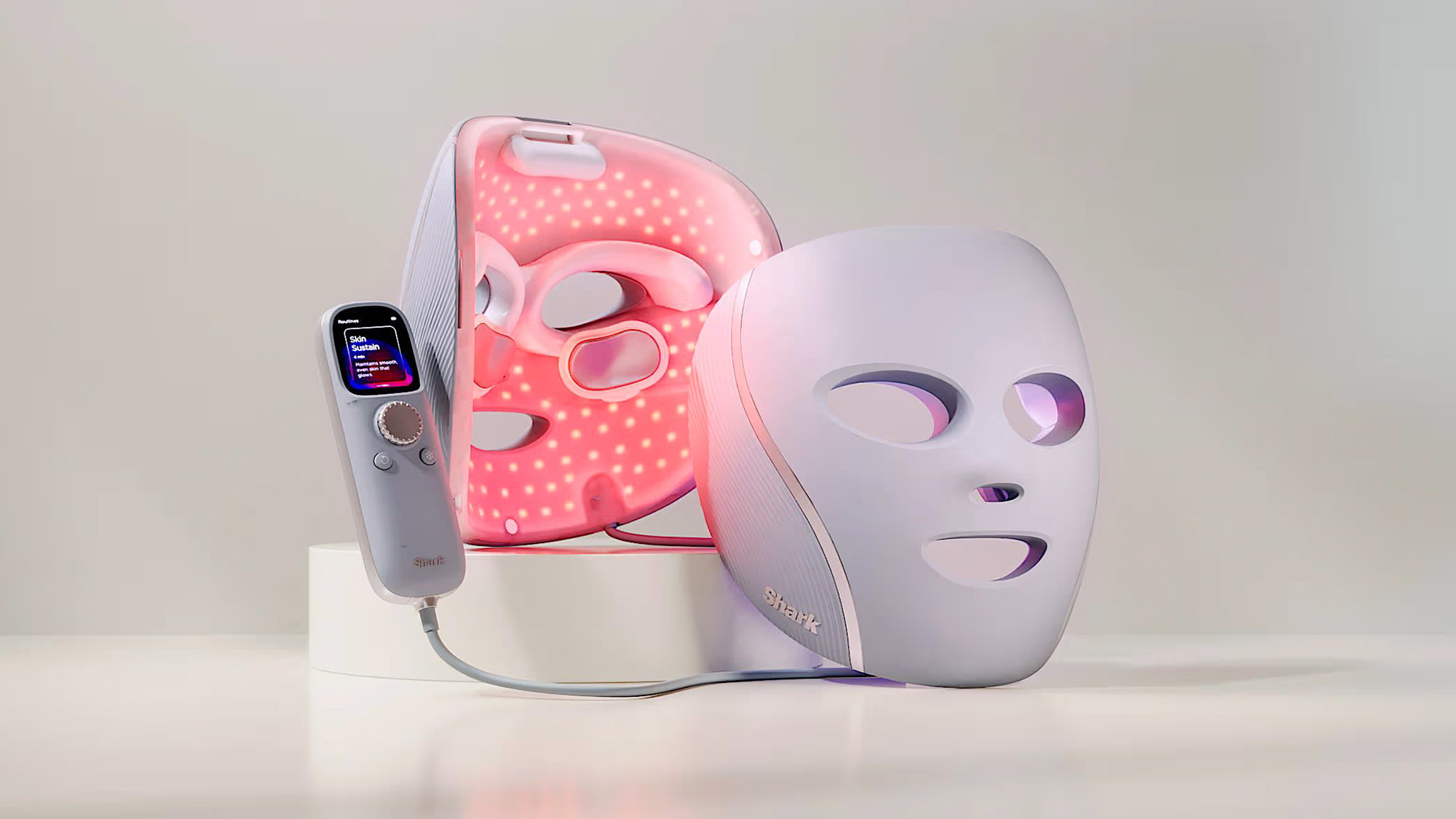 Shark light therapy facial mask and handheld device with pink LED lights illuminated