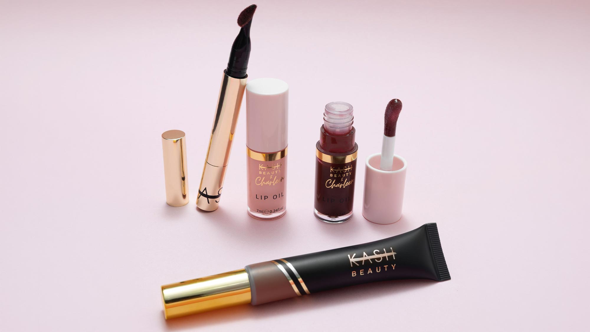 Kash Beauty lip products collection featuring lipsticks, lip oils and liquid lipsticks in burgundy and nude shades