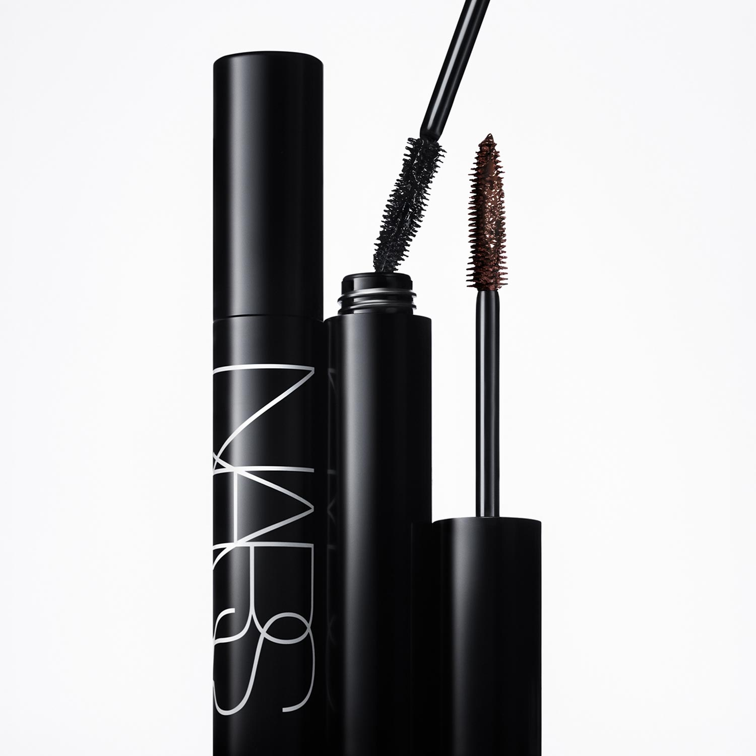 NARS Notorious Mascara in black with applicator wand showing black and brown formula swatches on white