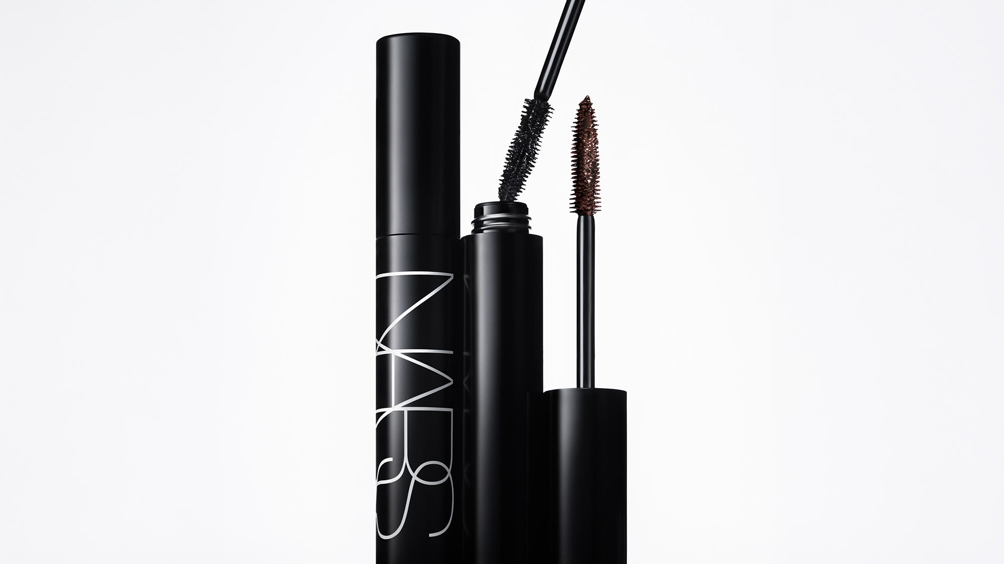 NARS Notorious Mascara in black with applicator wand showing black and brown formula swatches on white