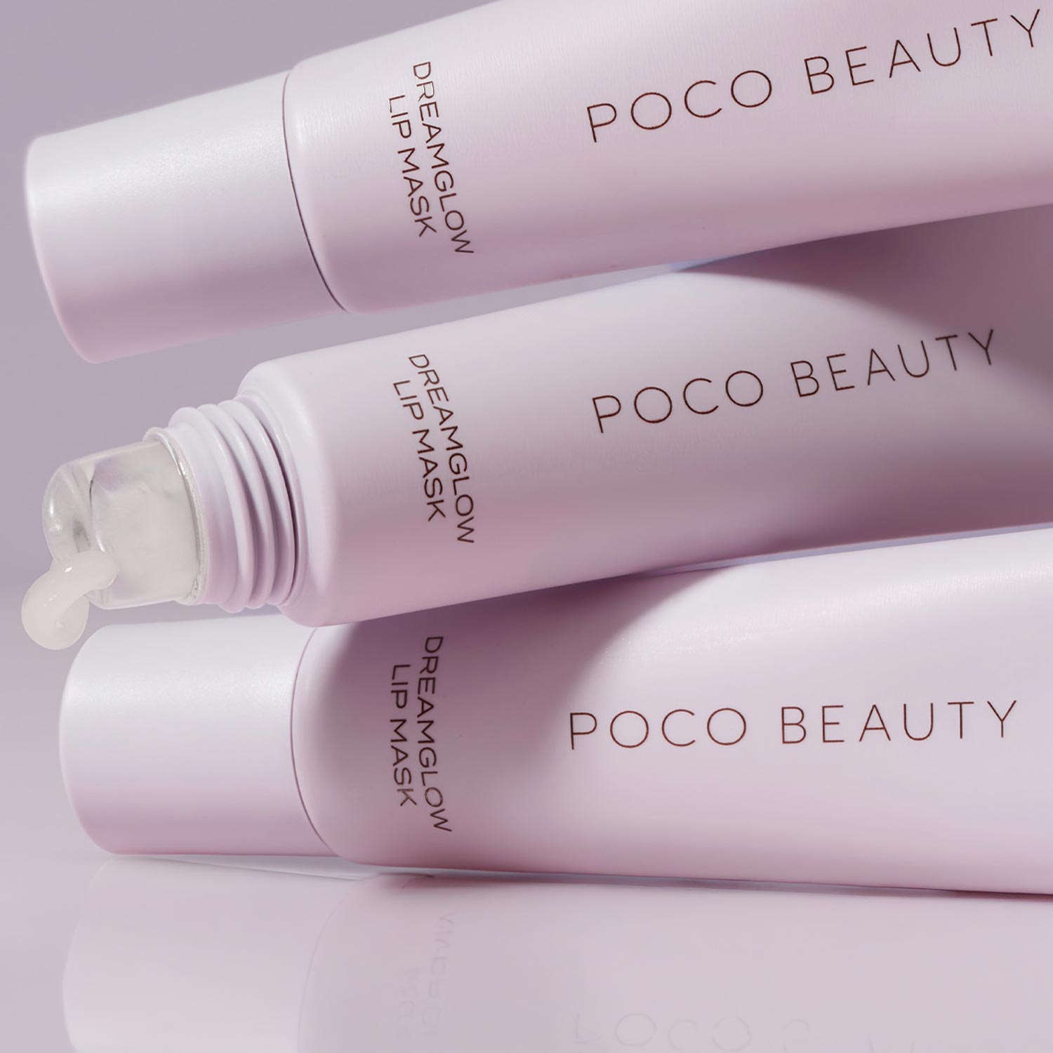 Three pink Poco Beauty dream glow lip mask products arranged on purple background