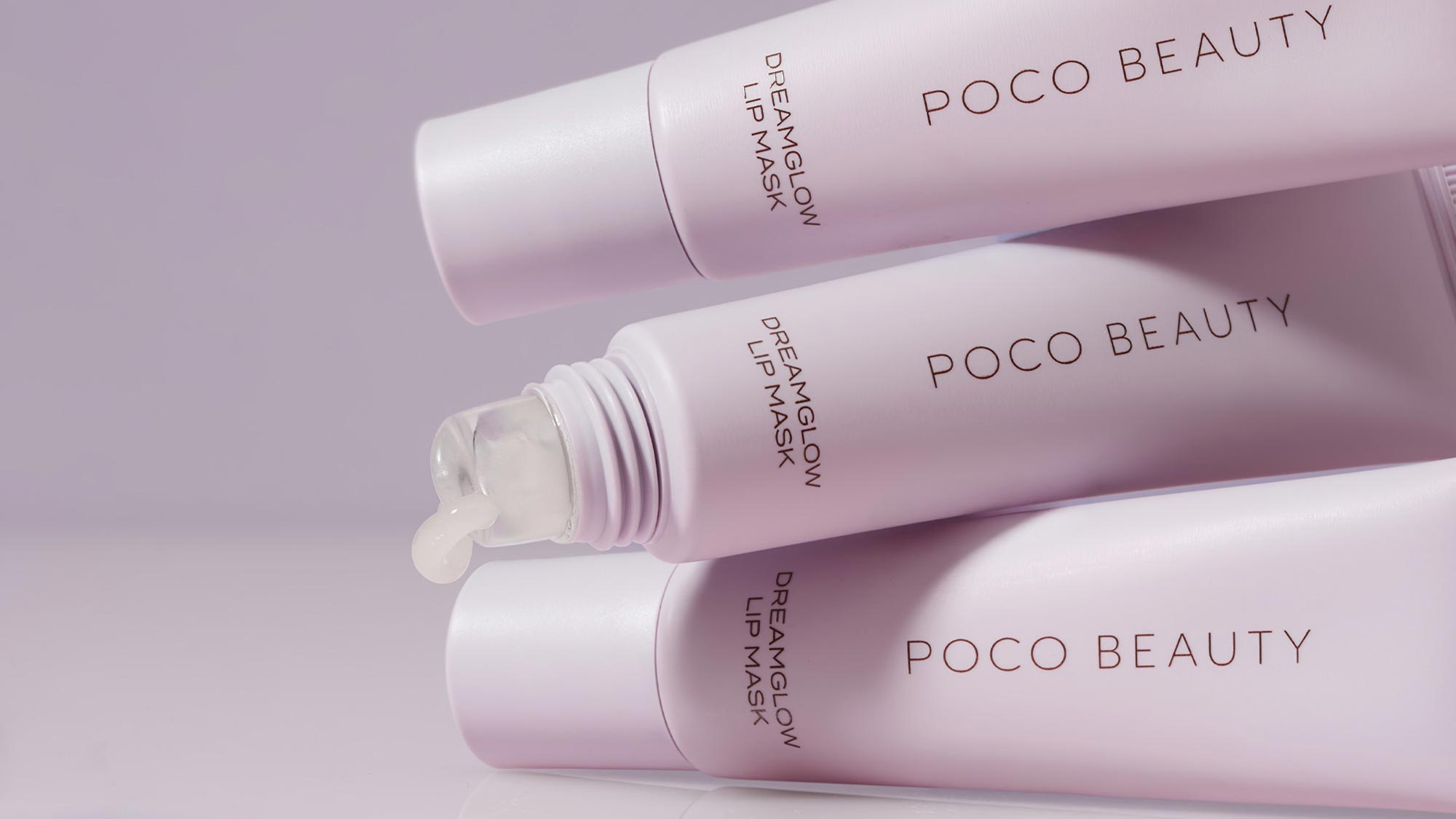 Three pink Poco Beauty dream glow lip mask products arranged on purple background