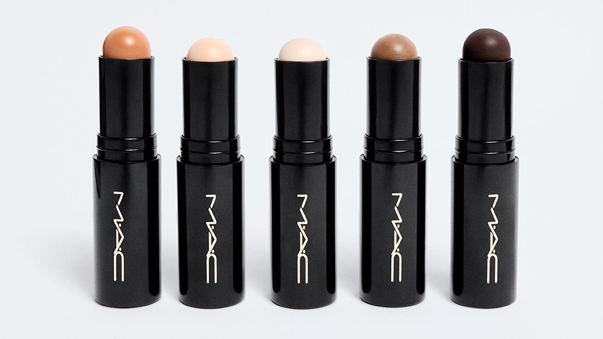 Five M.A.C Studio Radiance Skin Tint Stick tubes in varying shades ranging from light to deep skin tones
