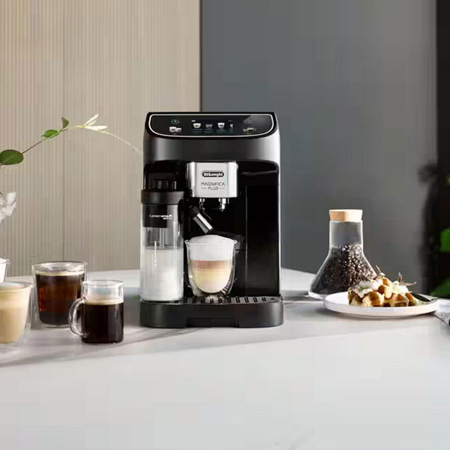 Delonghi coffee machine surrounded by cups of coffee, coffee beans, and fresh flowers on white table