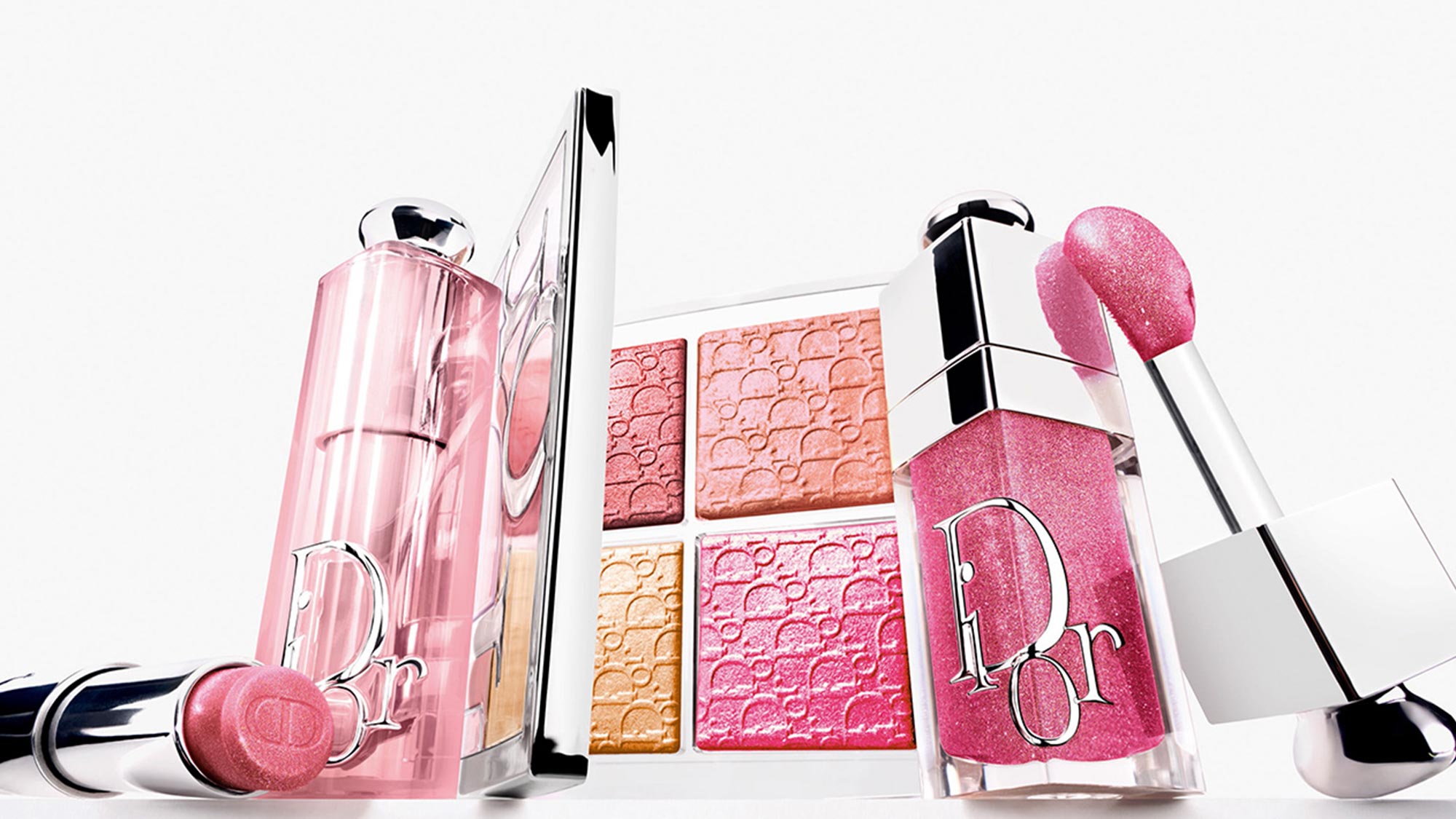 Dior Backstage makeup collection featuring pink Glow Maximizer Palette, Lip Glow oil, gloss and textured blush compacts in coral and pink shades