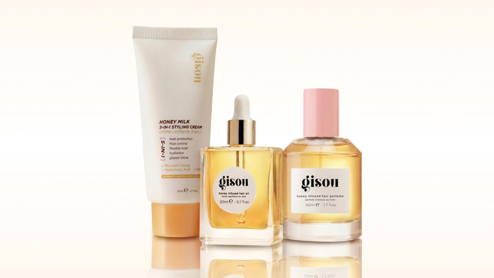 Gisou honey-infused hair care products including styling cream, hair oil and hair perfume with golden yellow packaging