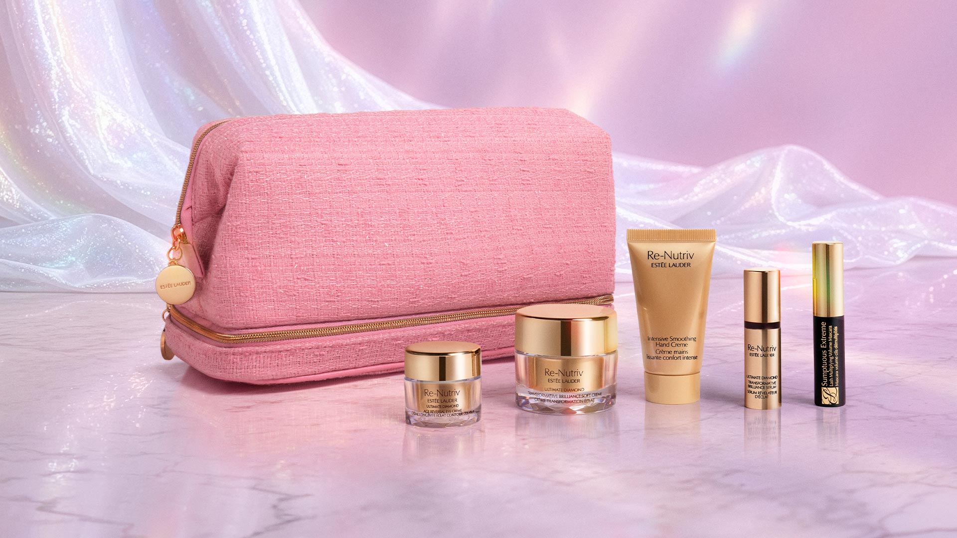Pink cosmetic bag with gold zip, surrounded by Re-Nutriv skincare and makeup products with gold packaging on pink marble background