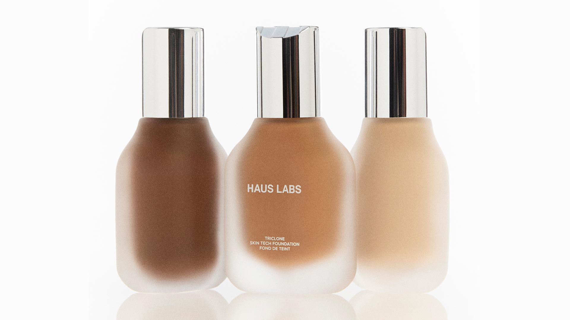 Three Haus Labs Triclone Skin Tech Foundation bottles in varying shades with silver caps