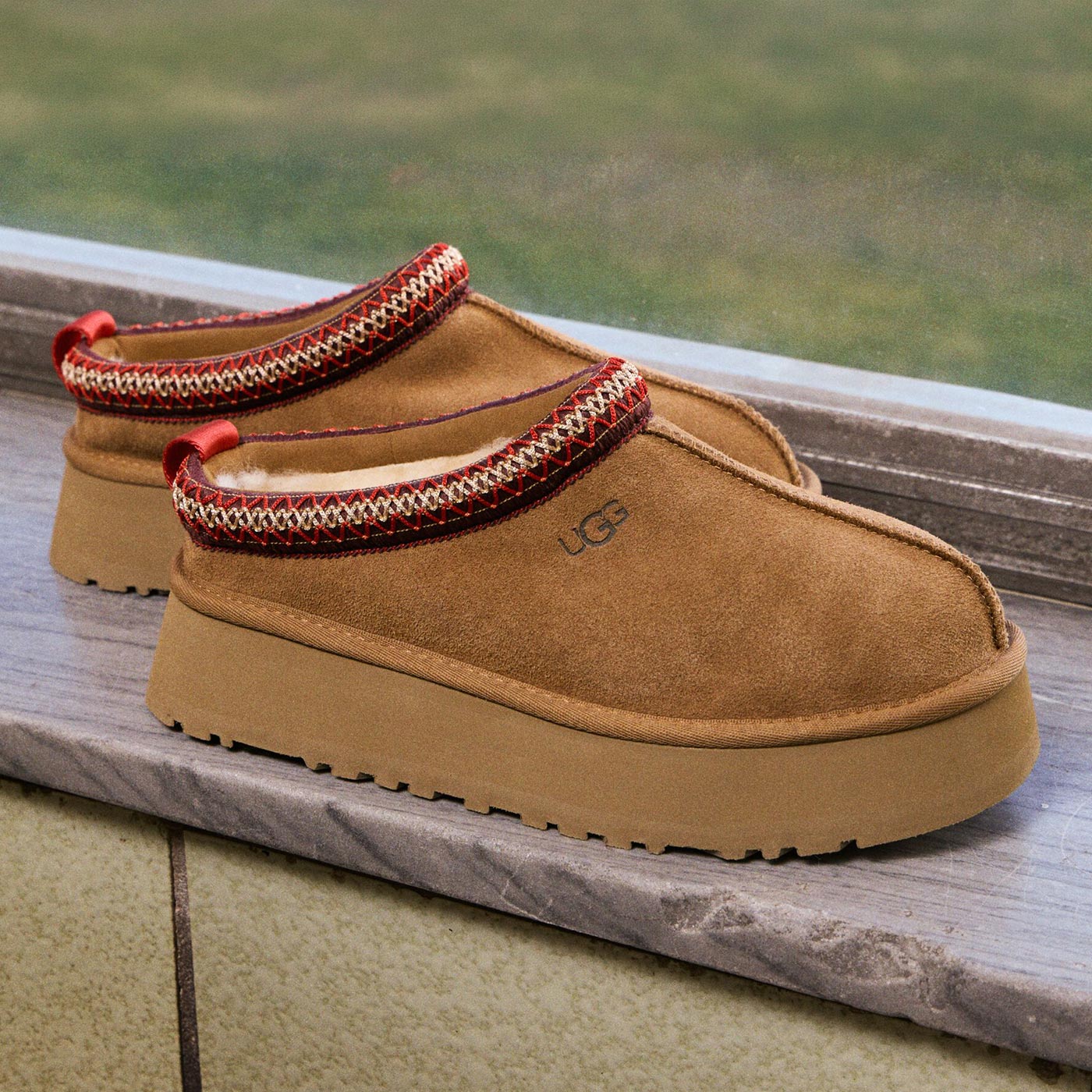 Pair of tan suede slip-on boots with red and cream knitted trim detail