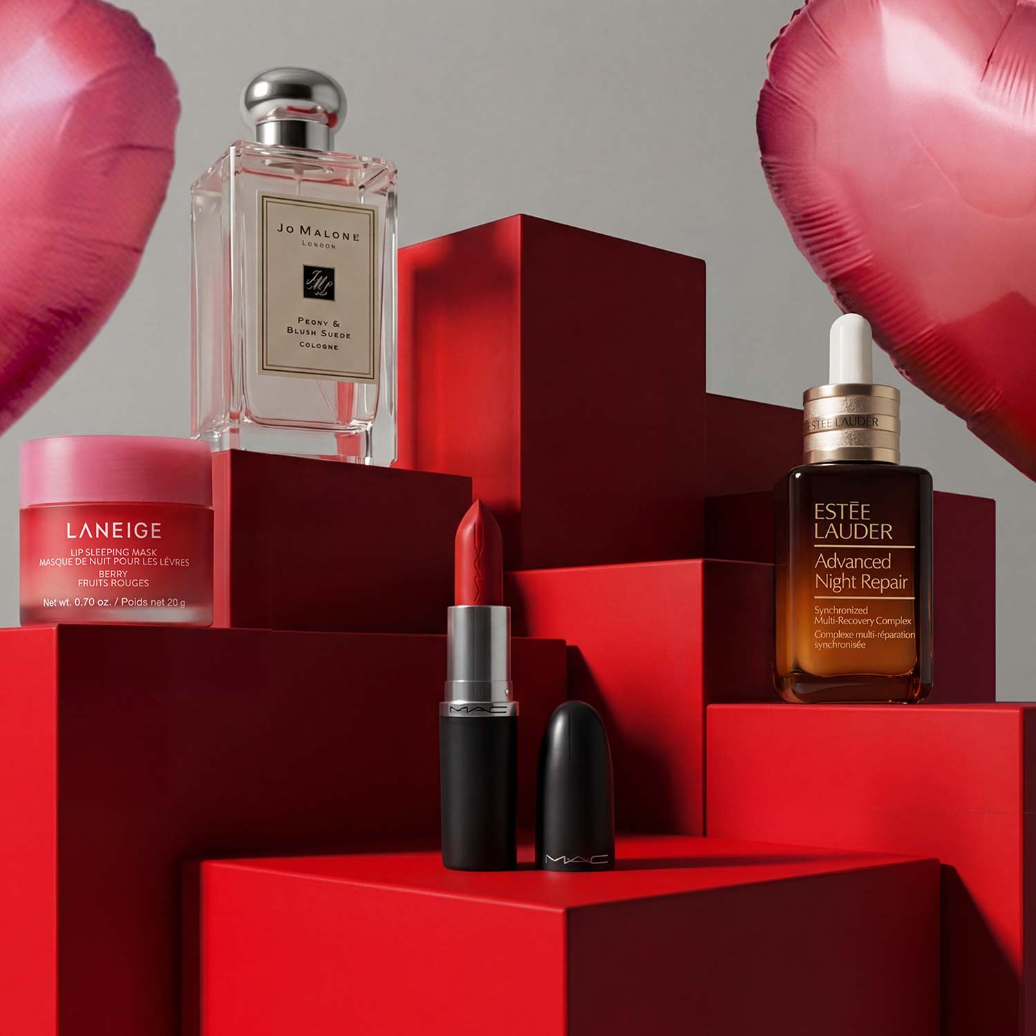 Beauty products displayed on red blocks with heart-shaped balloons in the background.