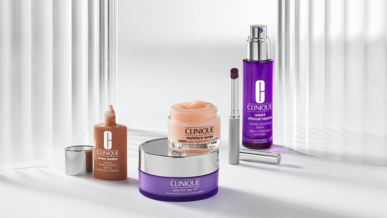 Clinique skincare and makeup products arranged on a light surface with a soft background.