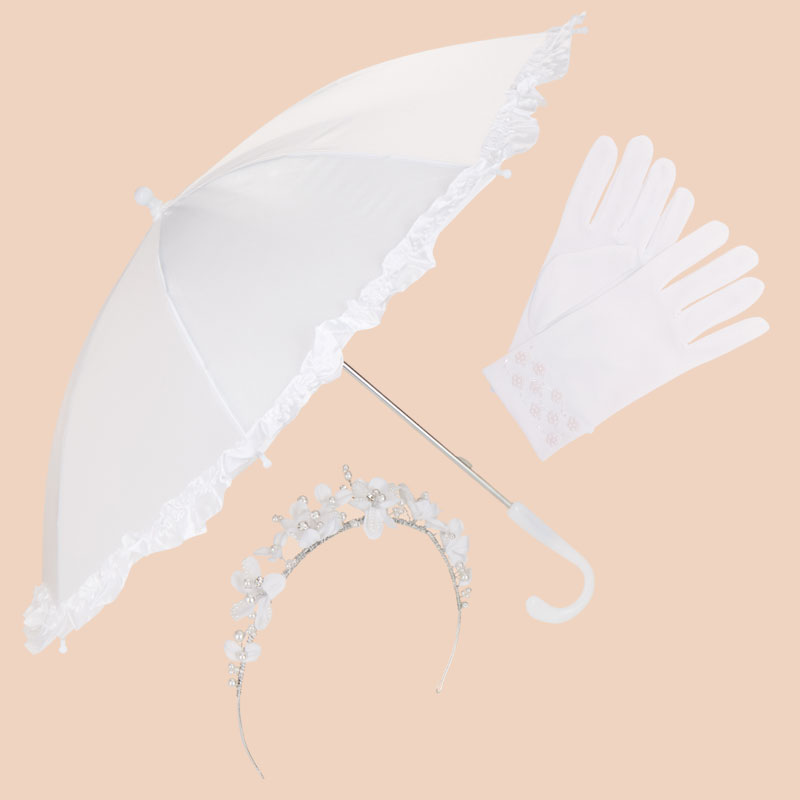 White parasol, gloves, and floral headband arranged on a beige background, representing communion accessories.