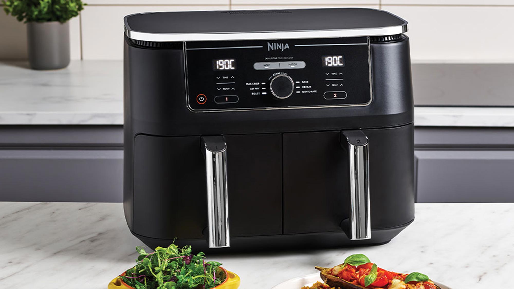 Black Ninja air fryer with digital display and chrome handles on kitchen counter