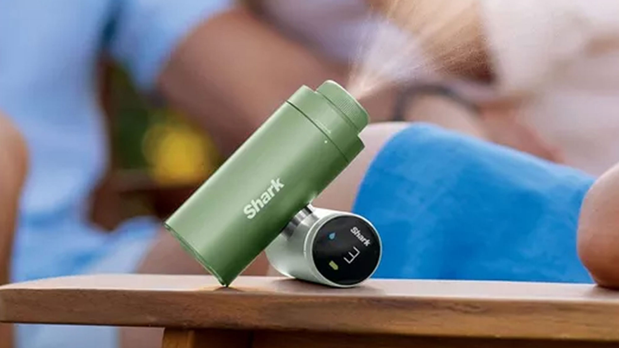 Shark Chill Pill 3 in 1 fan in green held in hand outdoors