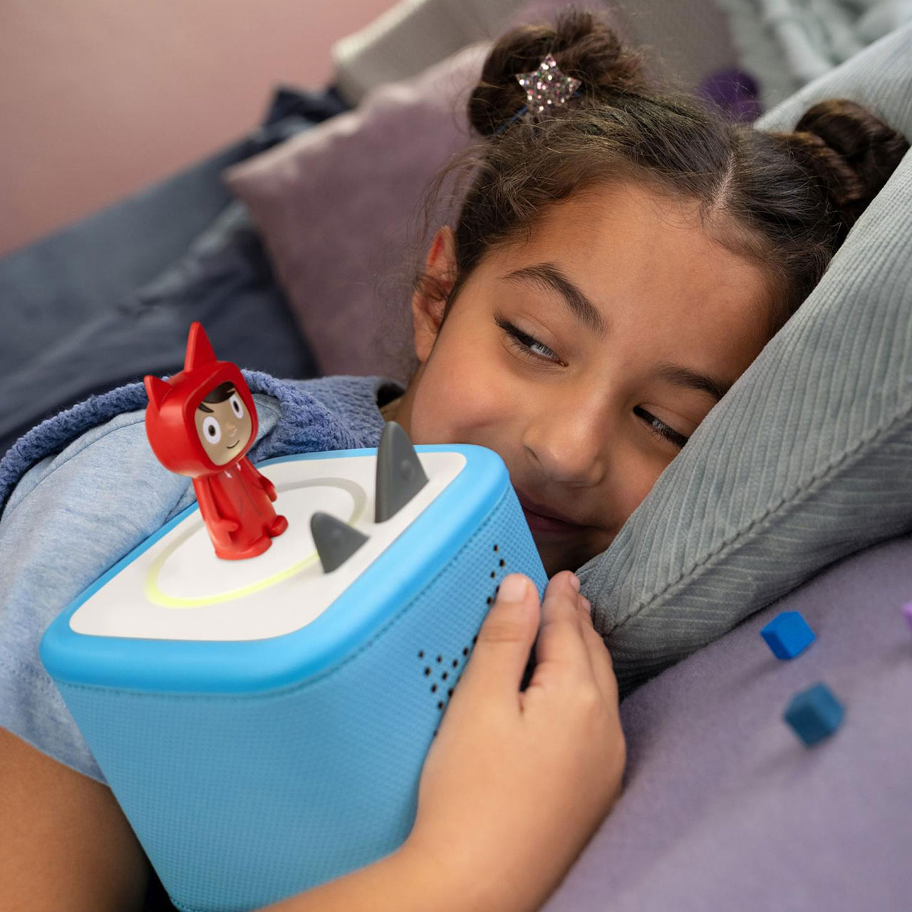 Child playing with interactive toy boat featuring red character figure during travel or holiday