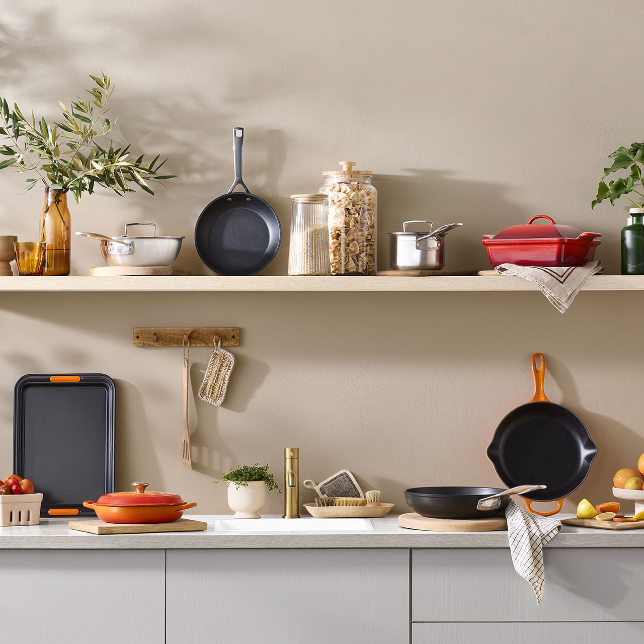 Kitchen shelf displaying cookware, storage jars, plants and utensils with savings up to 60% off home items