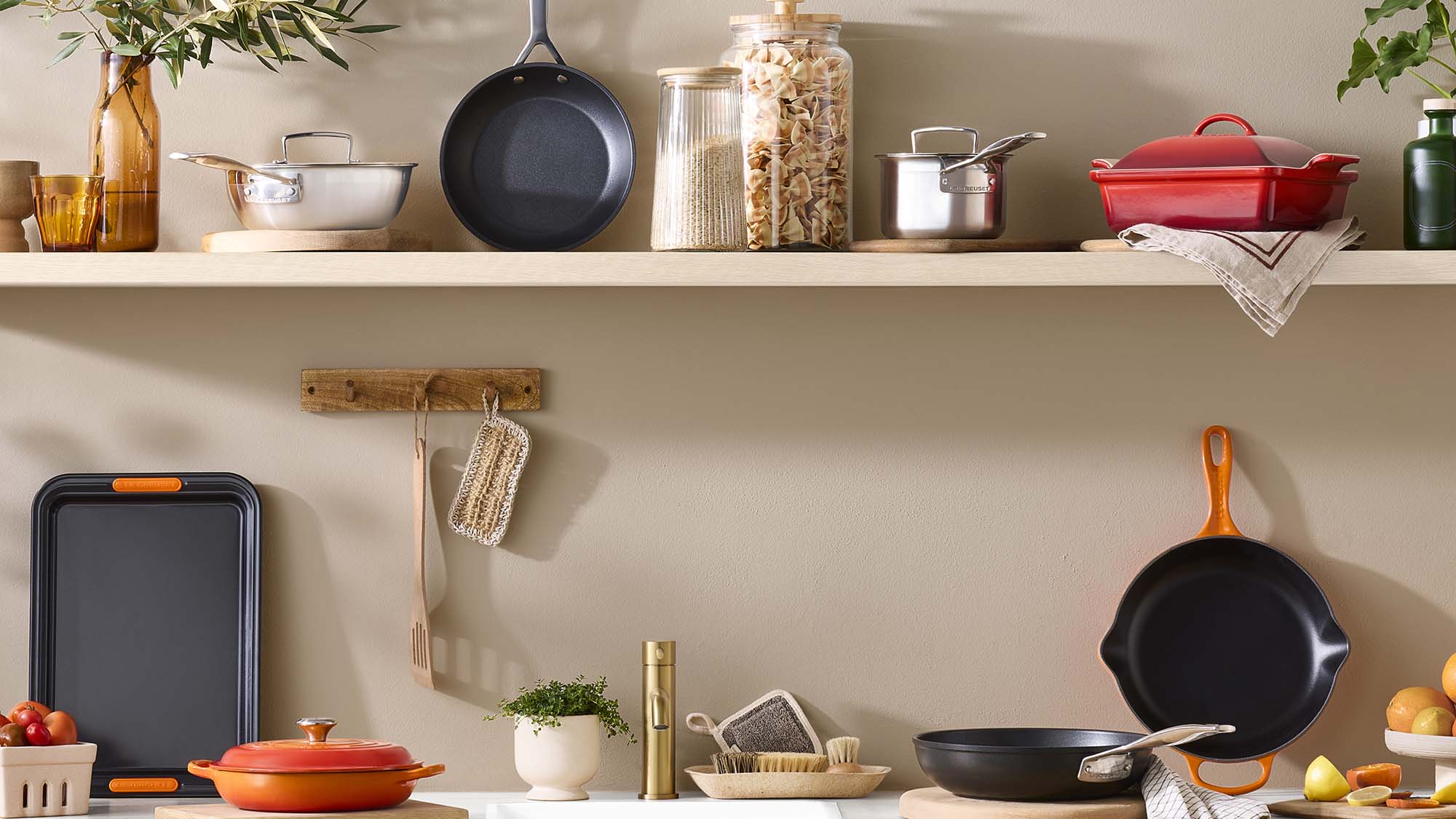 Kitchen shelf displaying cookware, storage jars, plants and utensils with savings up to 60% off home items