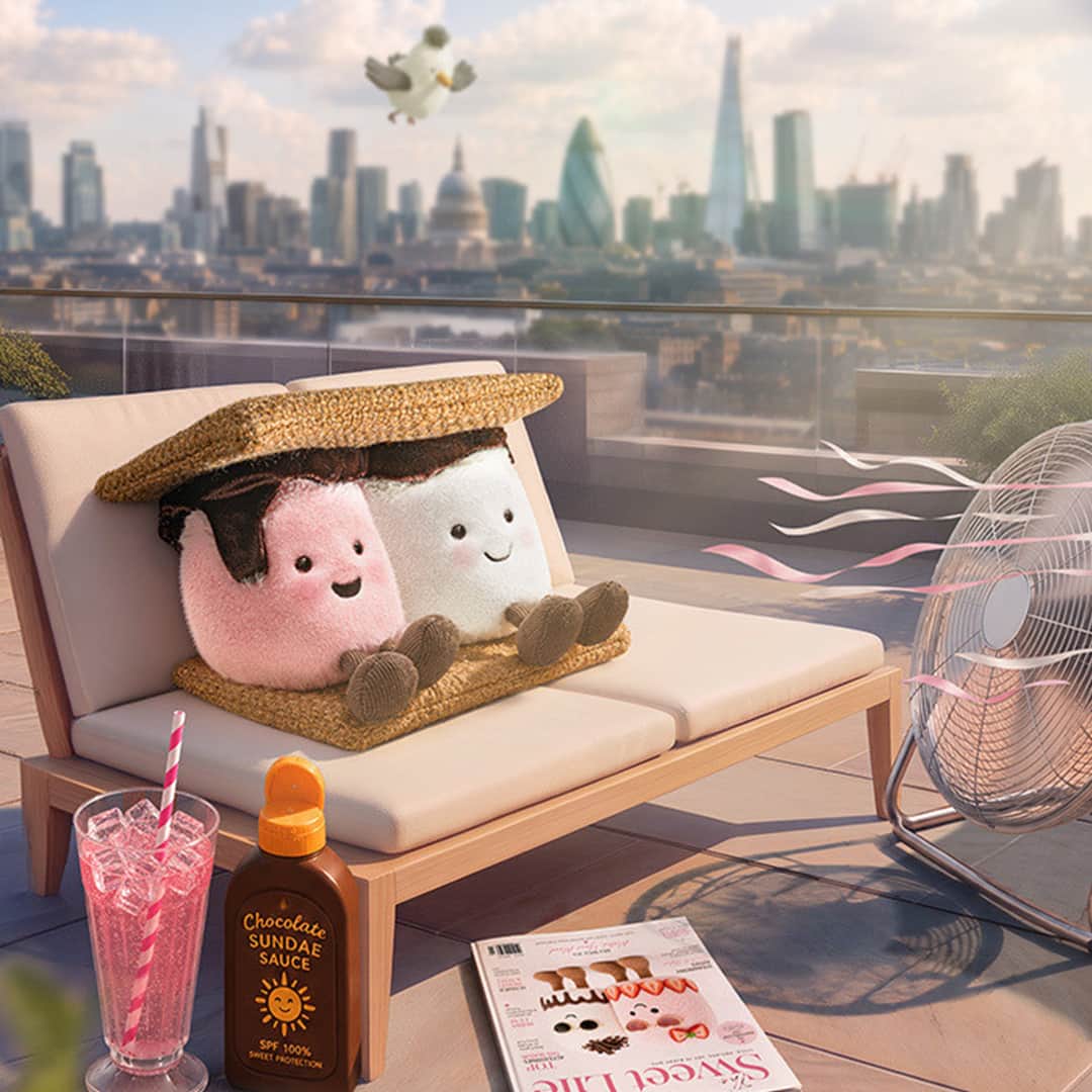 Colourful Jellycat plush toys relaxing on a sunny rooftop terrace with city skyline view