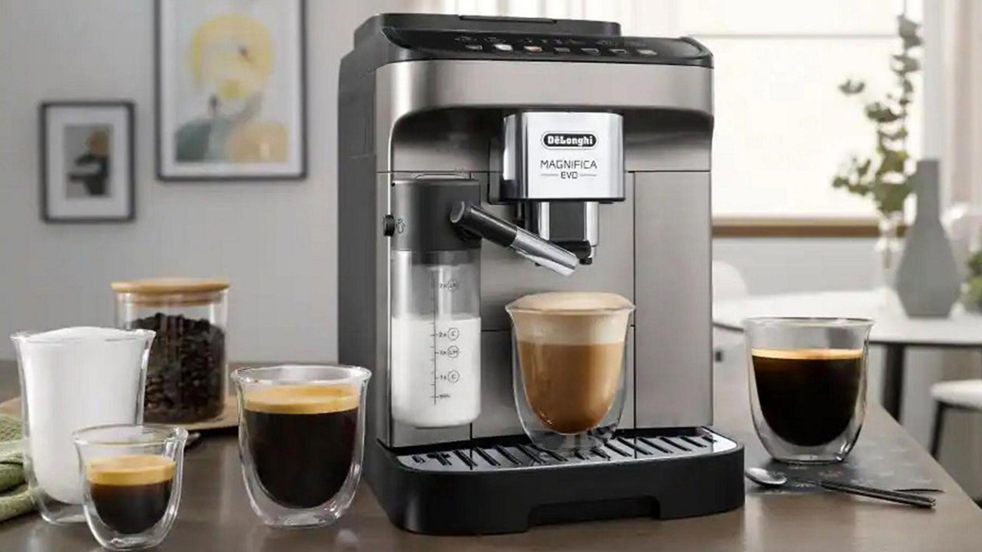 DeLonghi Magnifica Evo automatic coffee machine with espresso cups and coffee beans displayed on kitchen counter