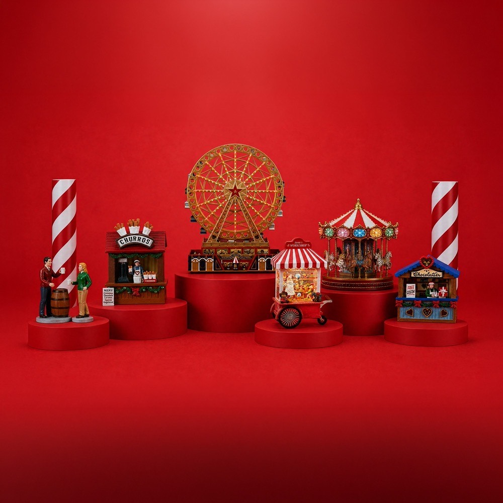 Miniature festive village scene with Ferris wheel, carousel, churro stand, workshop and chocolaterie kiosk