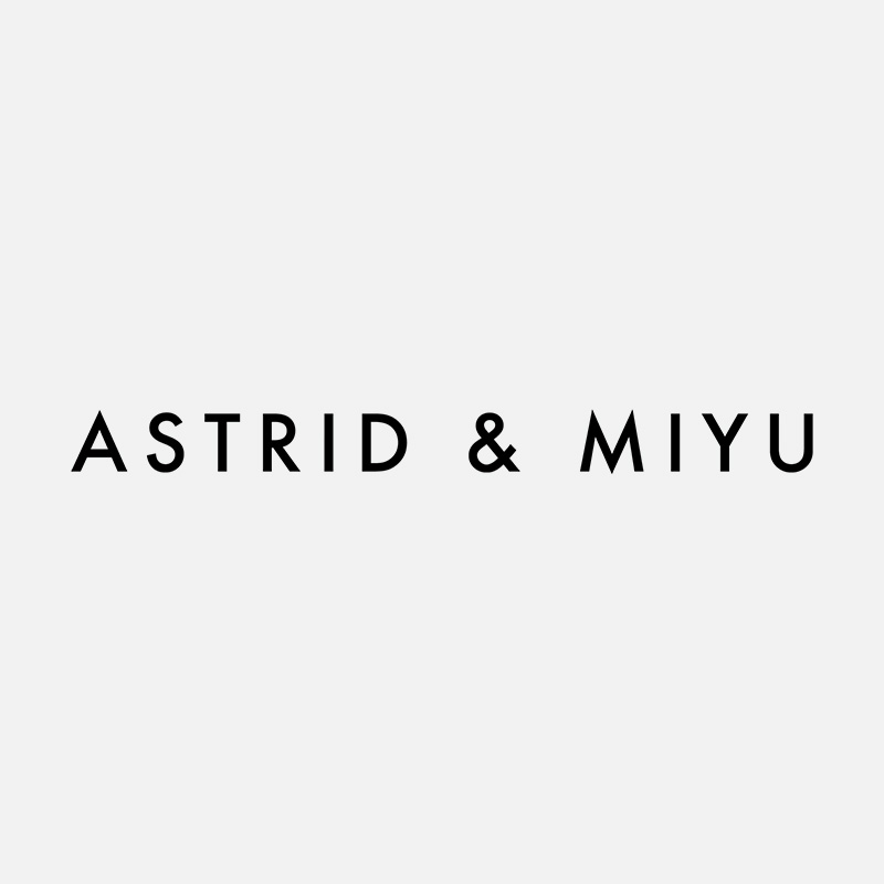 The image shows the text 'ASTRID & MIYU' in bold, black letters on a light gray background.