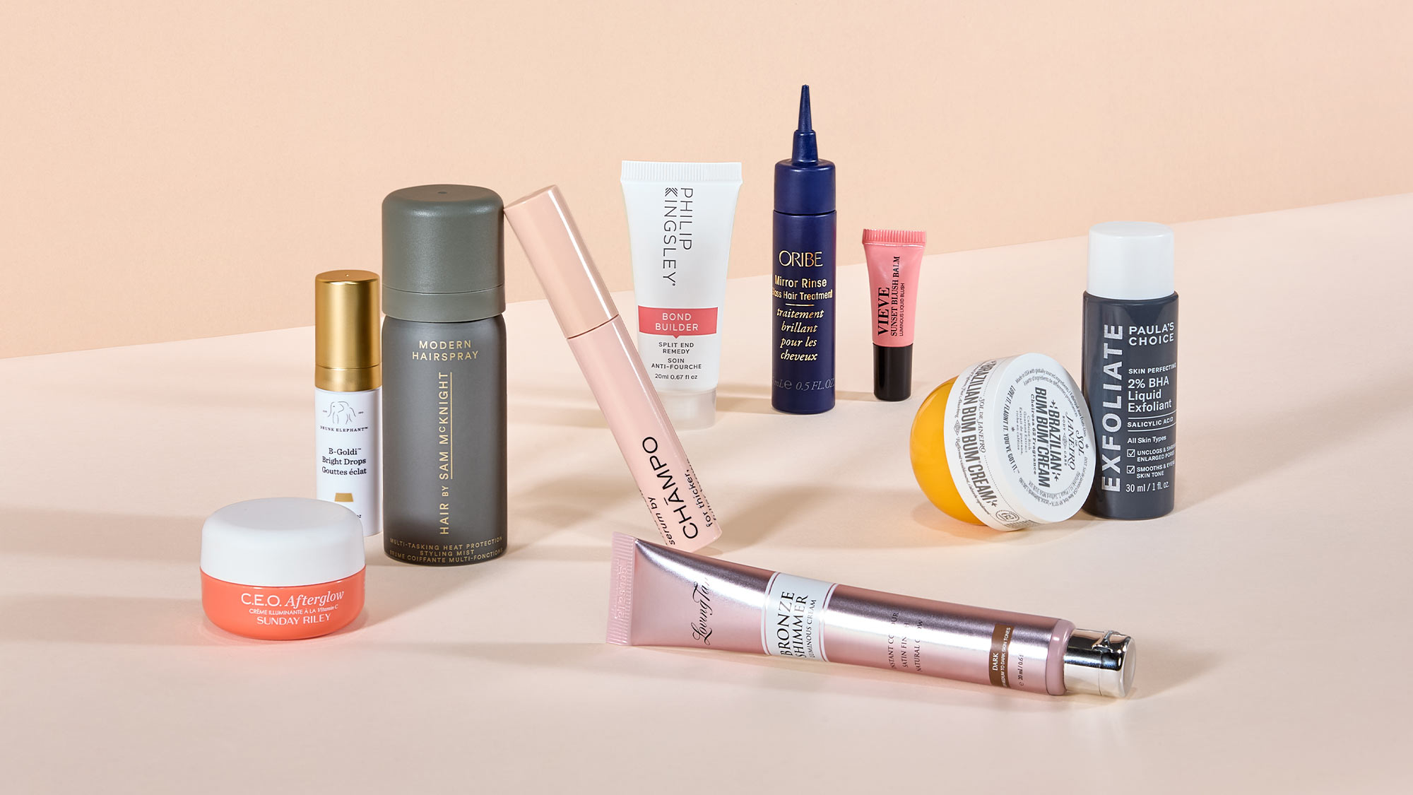 A variety of skincare and beauty products arranged on a light beige background.

