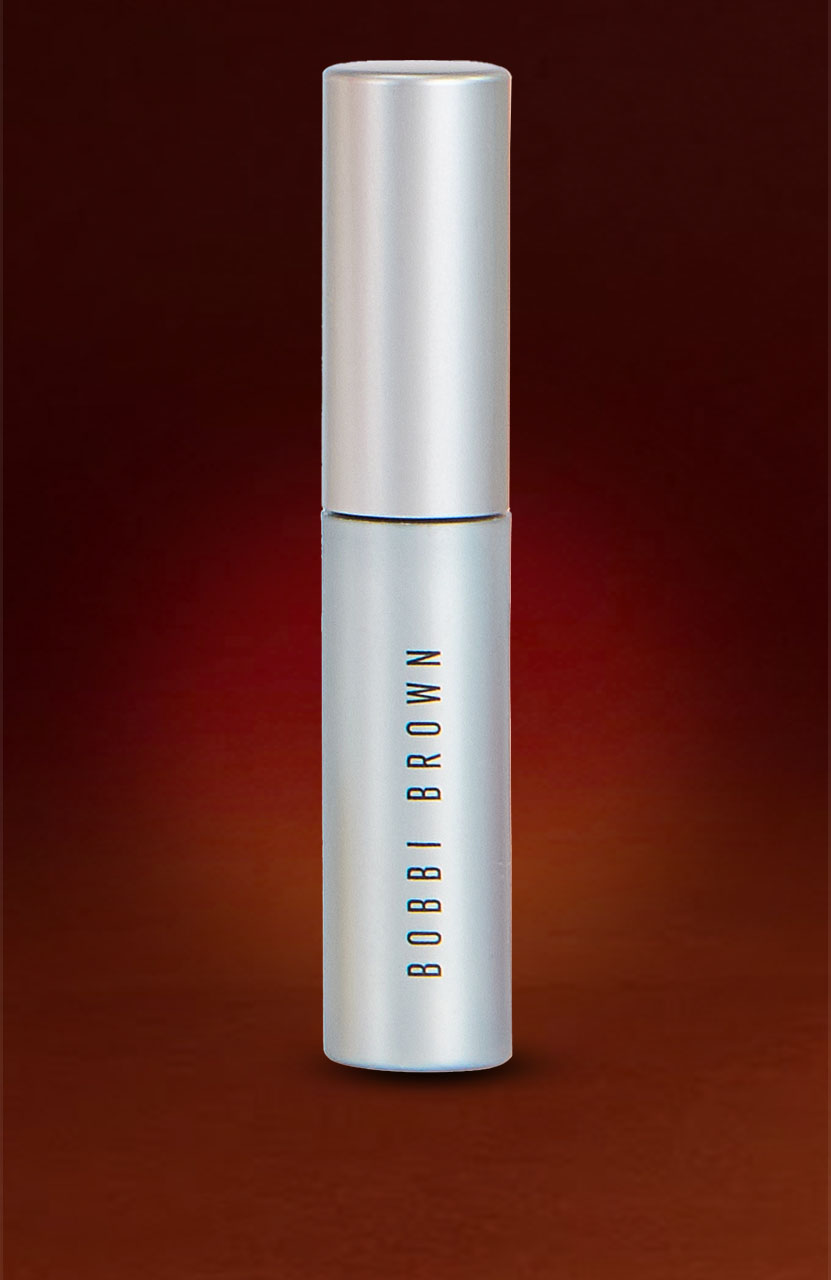 A silver cylindrical Bobbi Brown makeup product on a gradient red-brown background.