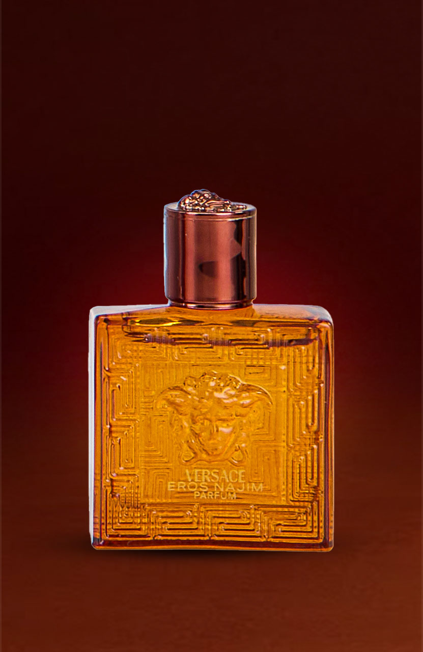 A square amber perfume bottle with intricate patterns and a dark cap, labeled 'Versace Eros Flame.'