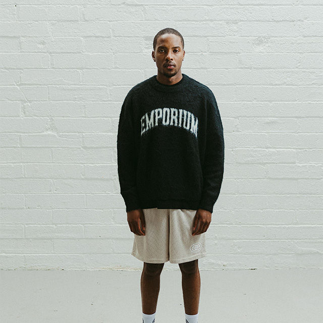 man wearing a black knitted jumper