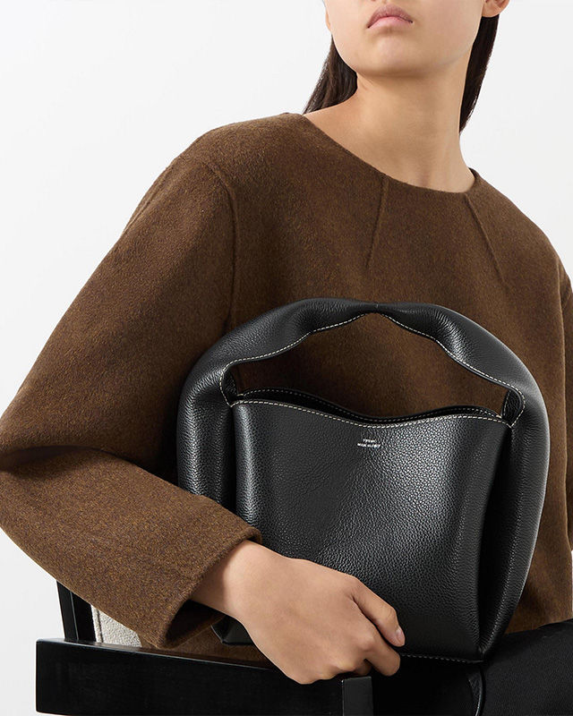 woman holding a black handbag