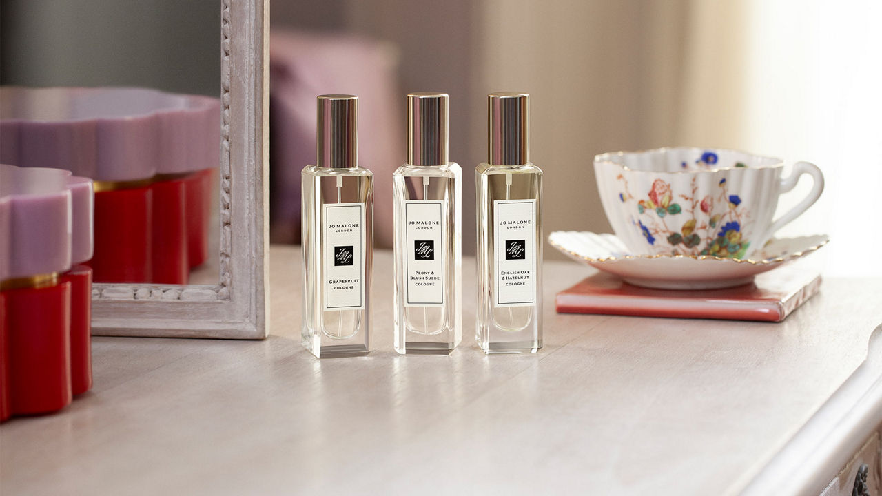 Jo Malone London fragrances next to a cup of tea