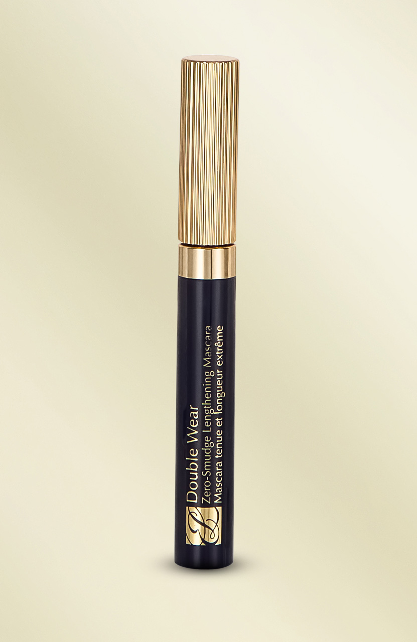 Black and gold mascara tube with text 'Double Wear' on a light background.