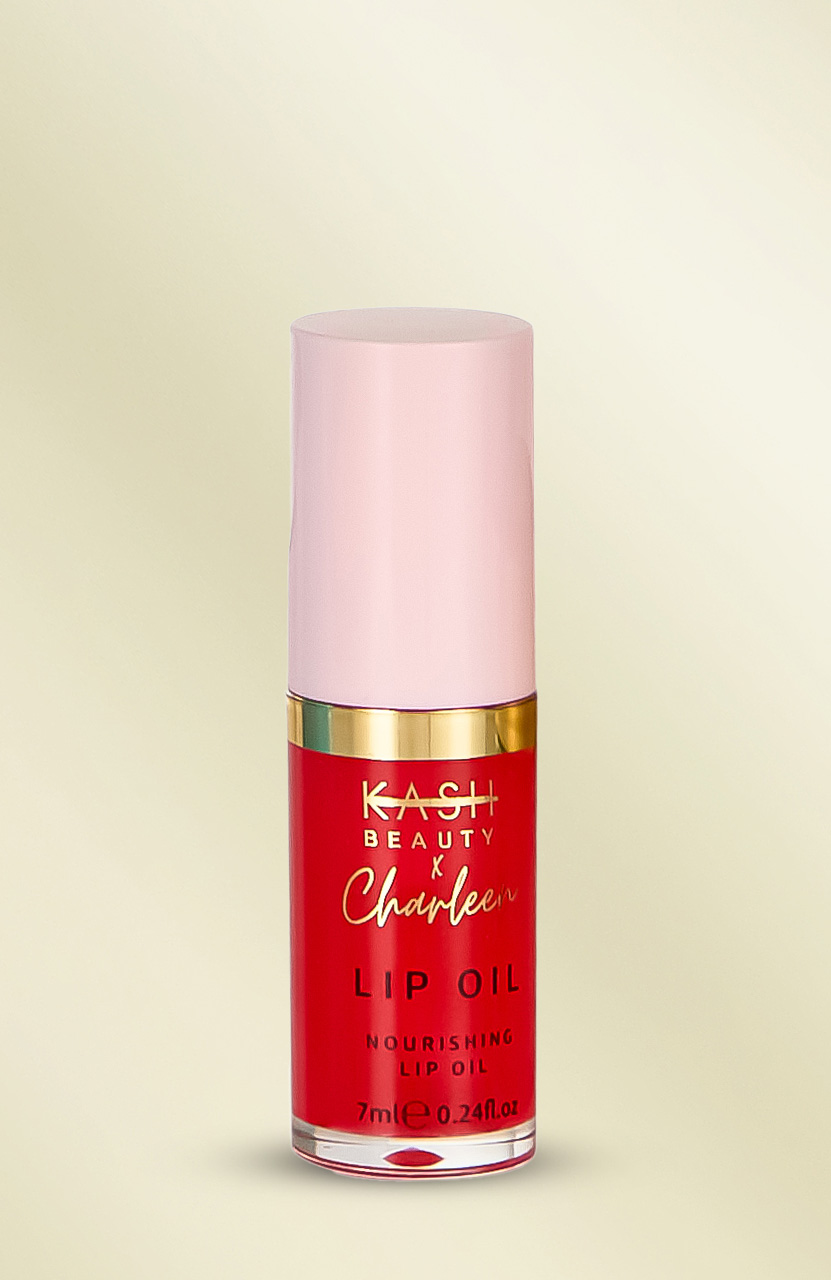 A red and pink tube of nourishing lip oil with gold accents on a light background.