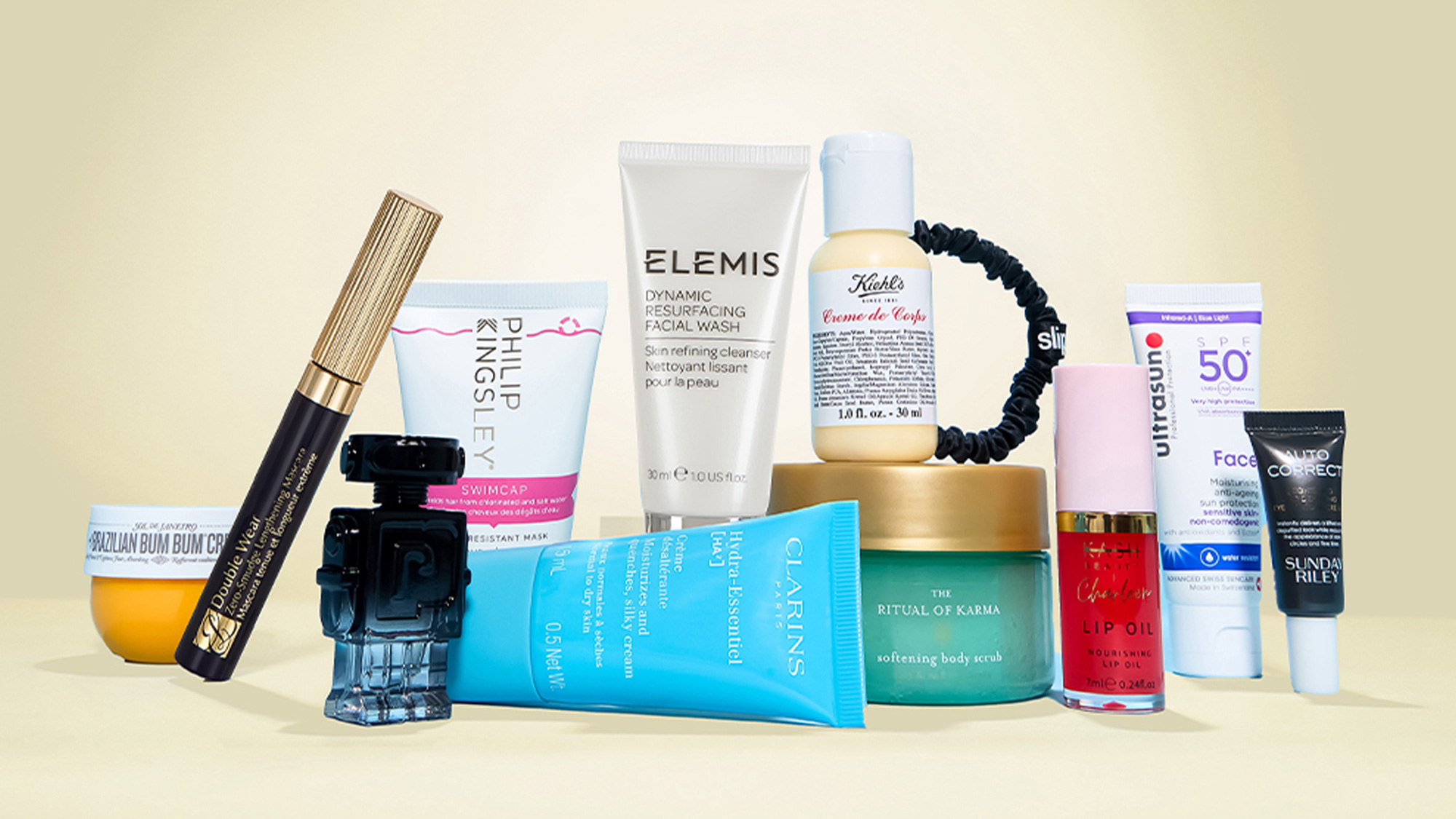 A variety of skincare and beauty products arranged on a light beige background.