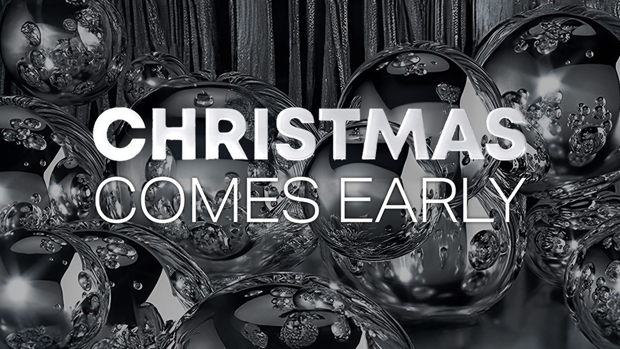Silver ornaments with the text 'CHRISTMAS COMES EARLY' overlaying the image.