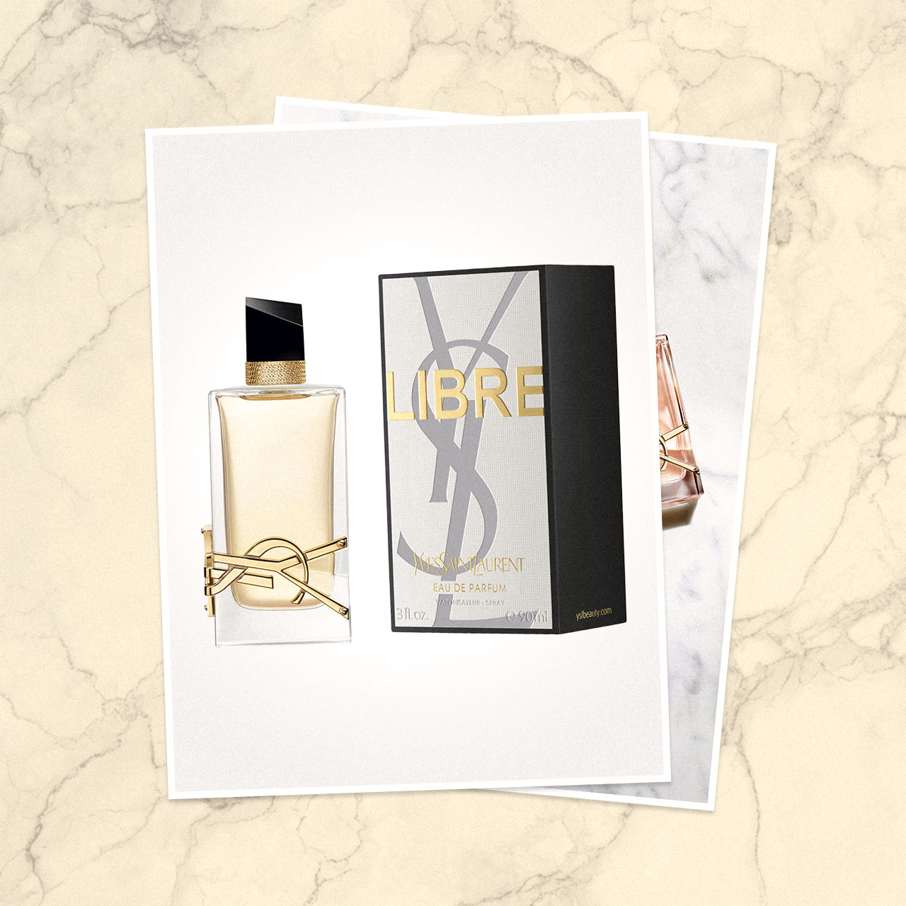 Yves Saint Laurent Libre fragrance bottle with box and additional perfume bottle displayed on marble background