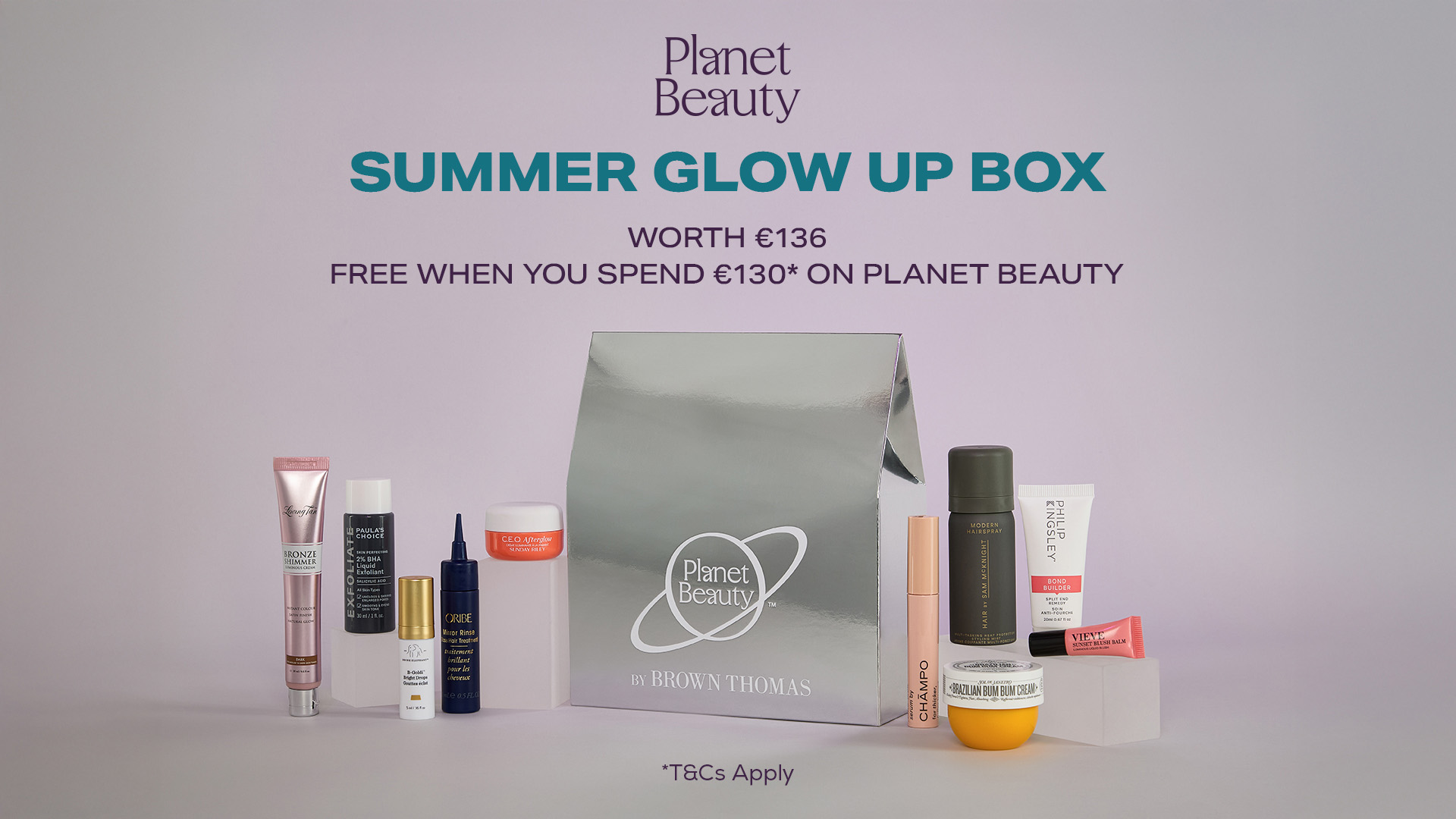 A collection of skincare products displayed around a silver box labeled 'Planet Beauty Summer Glow Up Box.'
