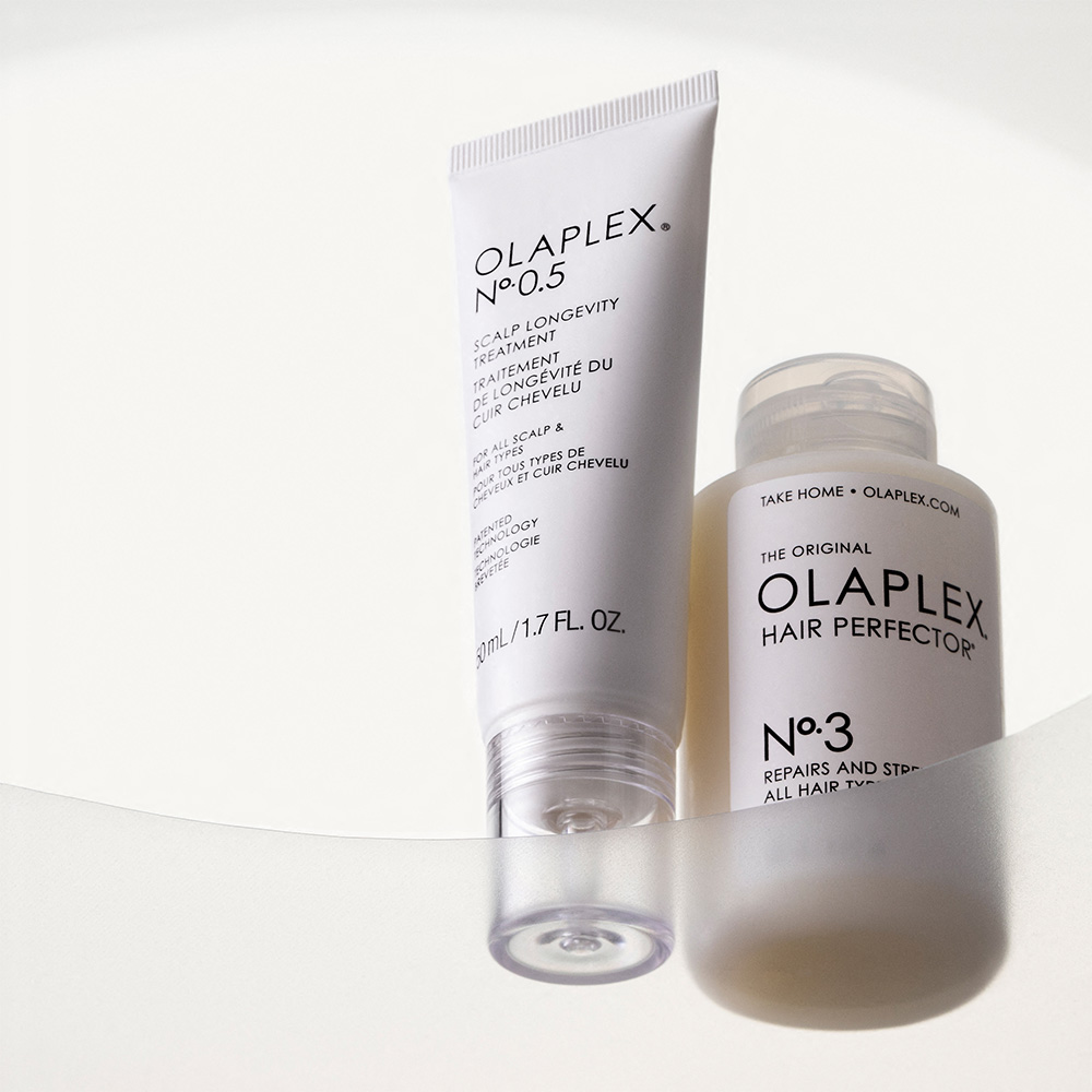 Olaplex scalp treatment tube and hair perfector bottle displayed on white background