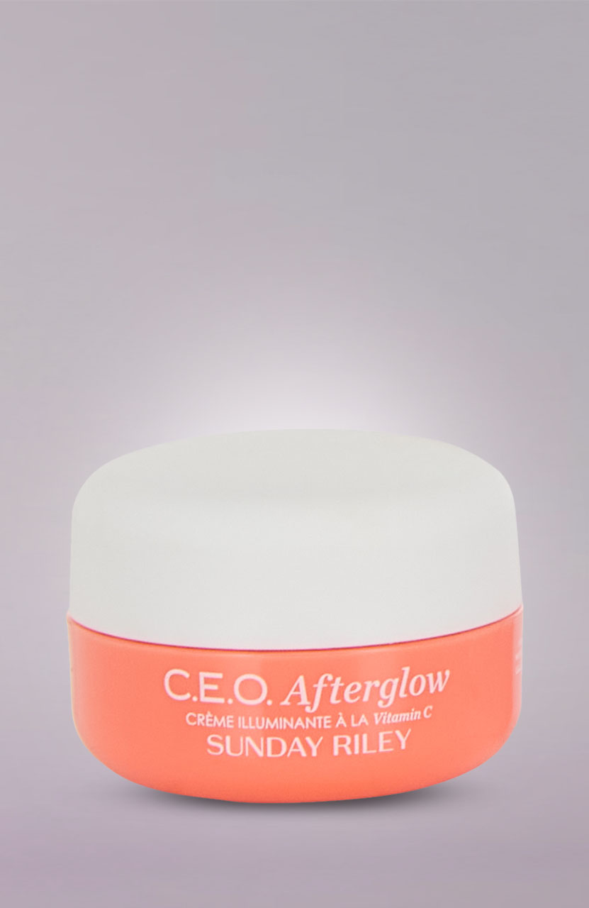 A jar of Sunday Riley C.E.O. Afterglow Vitamin C cream with a peach and white design on a light gradient background.'