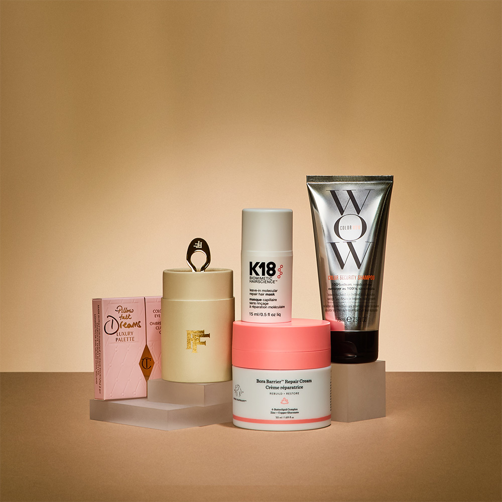 A selection of skincare and haircare products arranged on a beige background.