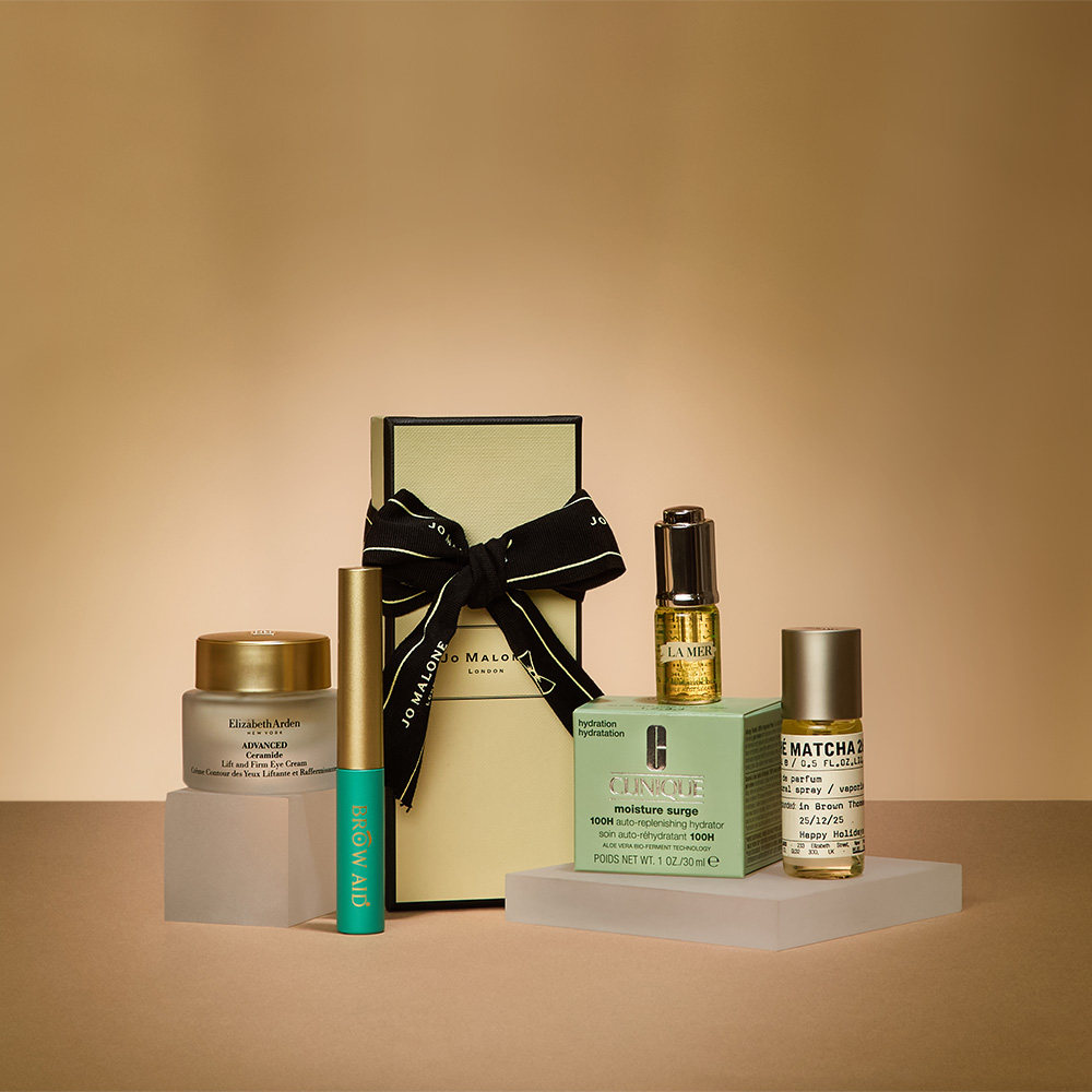 A collection of skincare and fragrance products displayed on geometric platforms against a neutral background.