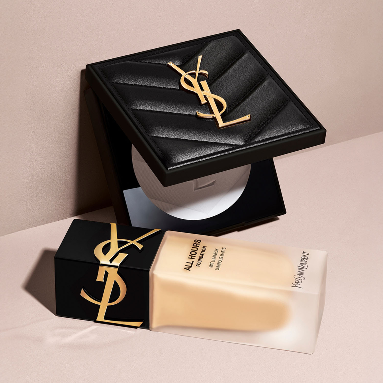 A bottle of YSL All Hours foundation lies next to a black box with the YSL logo.