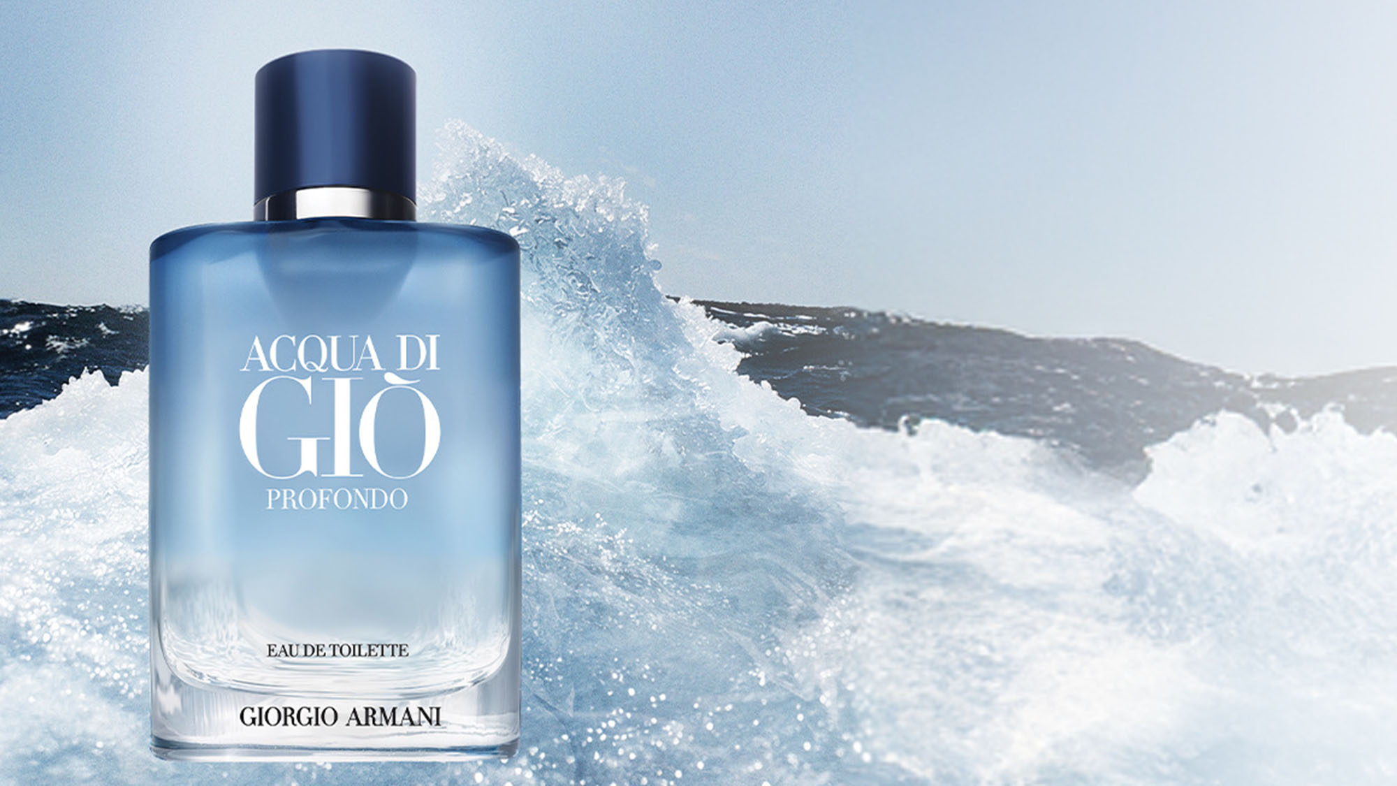 A blue bottle of Acqua di Giò Profondo by Giorgio Armani against a backdrop of ocean waves.