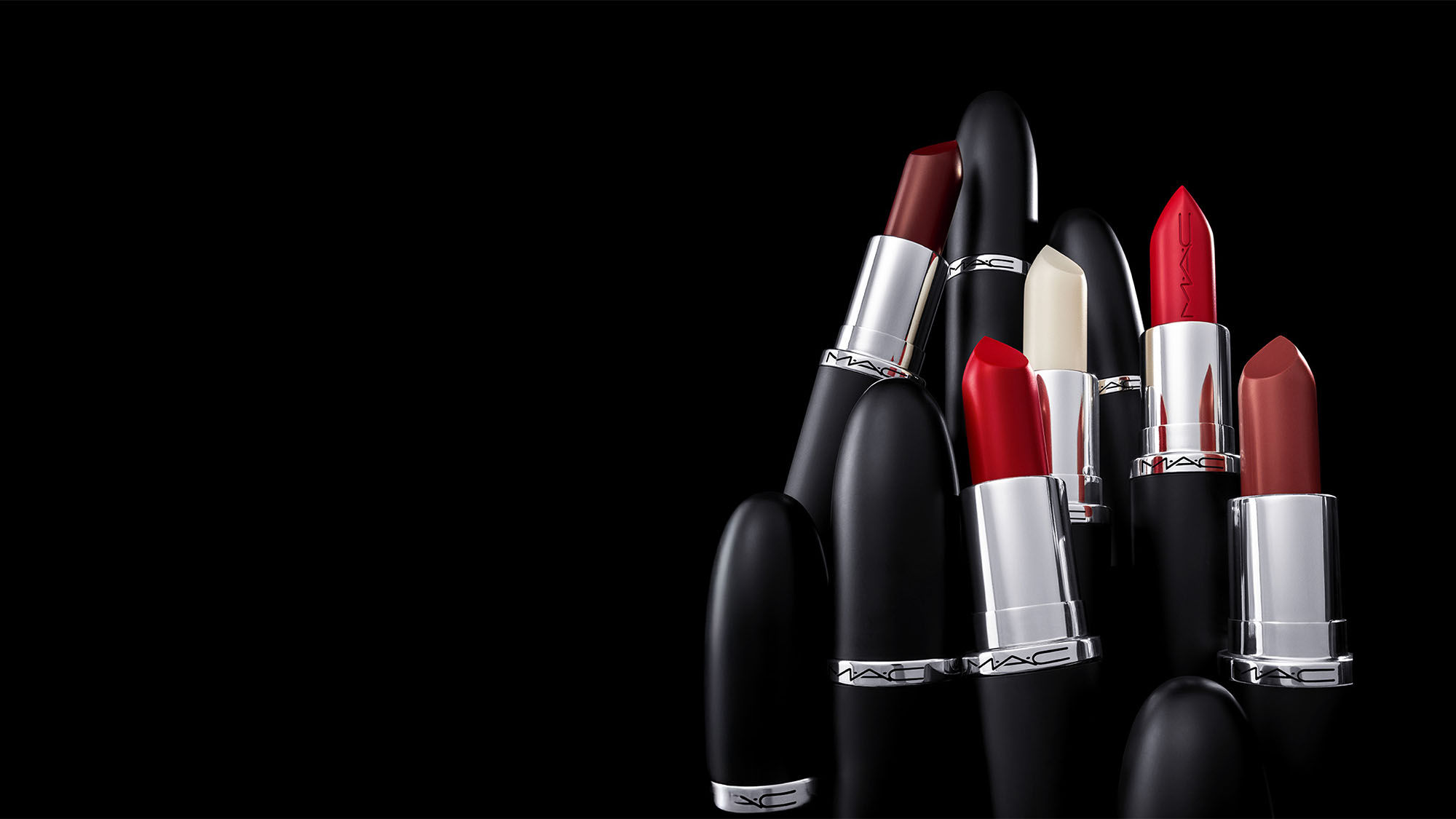 A collection of MAC lipsticks in various shades, with sleek black packaging.